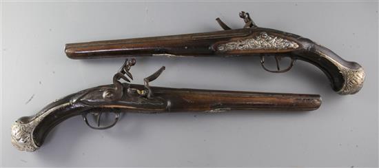 A pair of Turkish silver mounted mahogany flintlock pistols, circa 1800, 48cm.